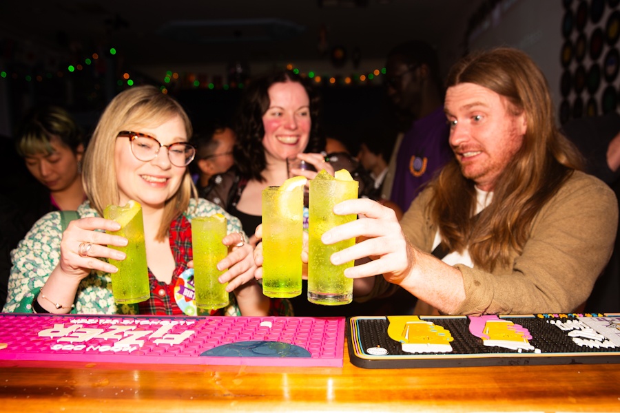 Friends raising their drinks at the Benjys bar